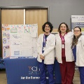 Community Health Fair partners stand in front of their informational booth at Main Library, sharing health resources and services with visitors.